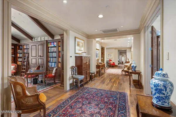 a living room with furniture and large windows