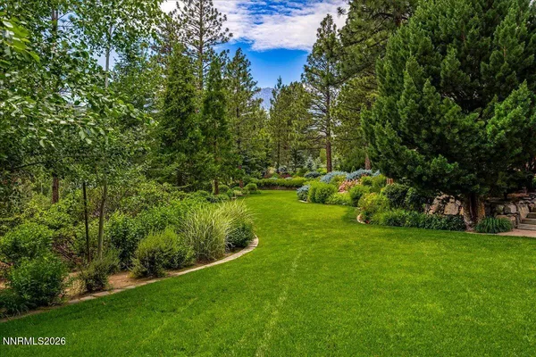 an aerial view of a house with a yard and garden