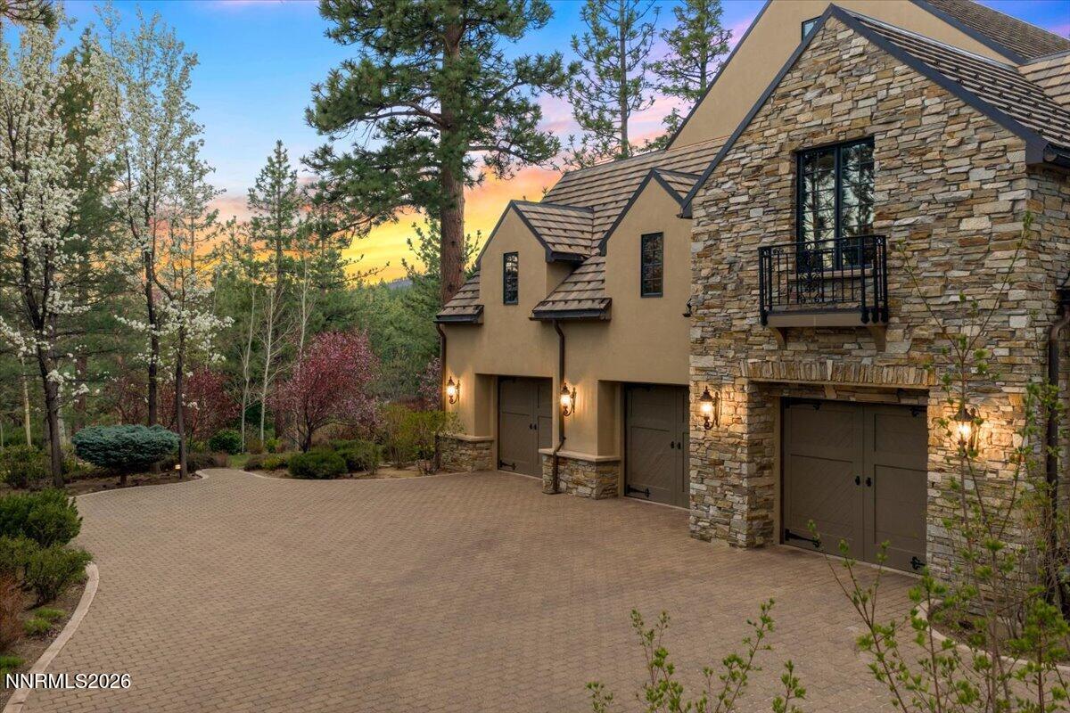 6025 Lake Geneva Drive Reno, NV 89511 - Photo 52 of 72 a view of a white house with a large tree
