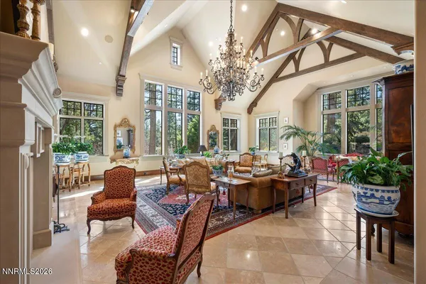 a living room with furniture and large windows