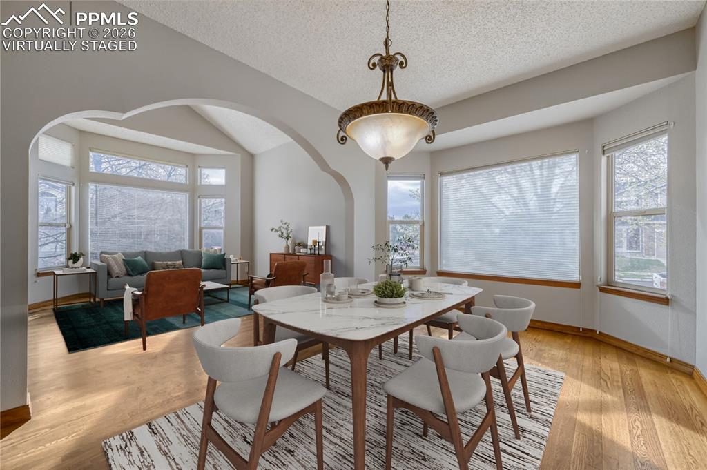 7215 Native Circle Colorado Springs, CO 80919 - Photo 12 of 30 a view of a dining room with furniture wooden floor and chandelier