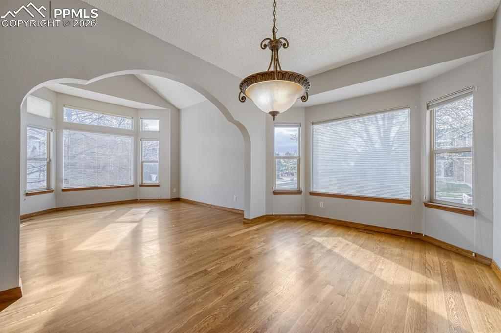 7215 Native Circle Colorado Springs, CO 80919 - Photo 13 of 30 a view of an empty room with a window and wooden floor