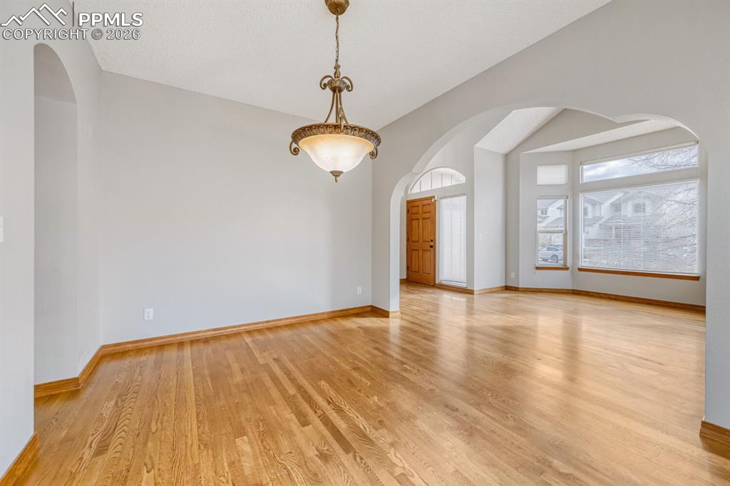 7215 Native Circle Colorado Springs, CO 80919 - Photo 14 of 30 a view of an empty room with wooden floor and a window