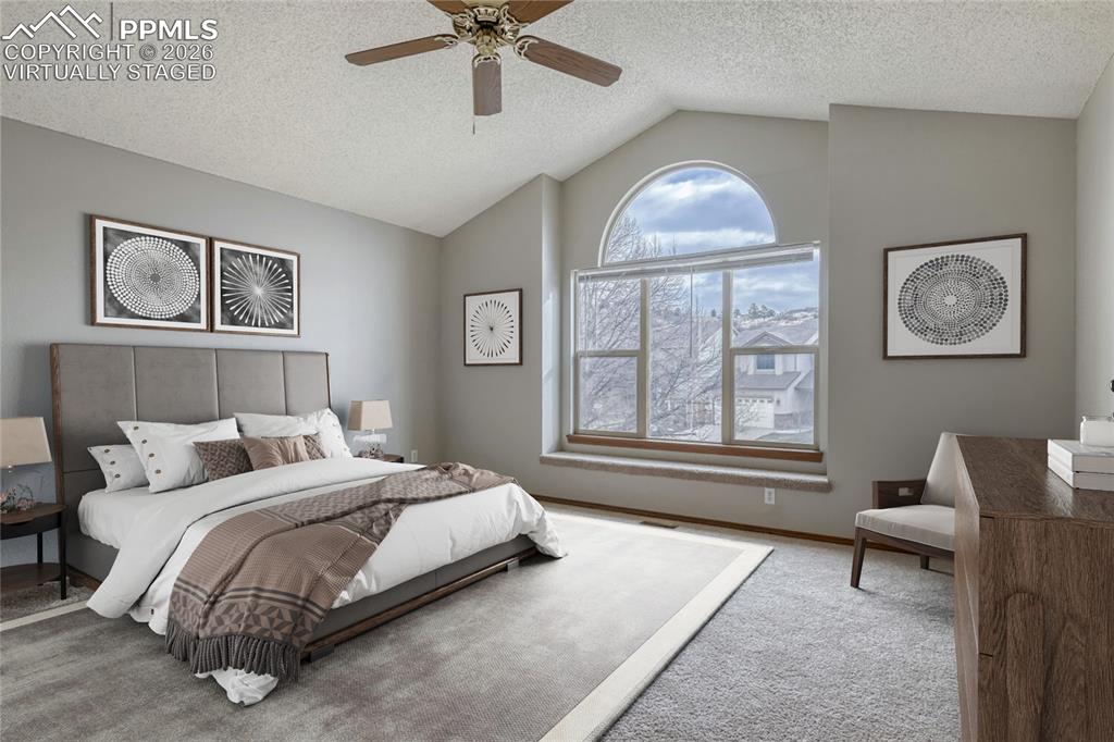 7215 Native Circle Colorado Springs, CO 80919 - Photo 15 of 30 a spacious bedroom with a bed and a couch