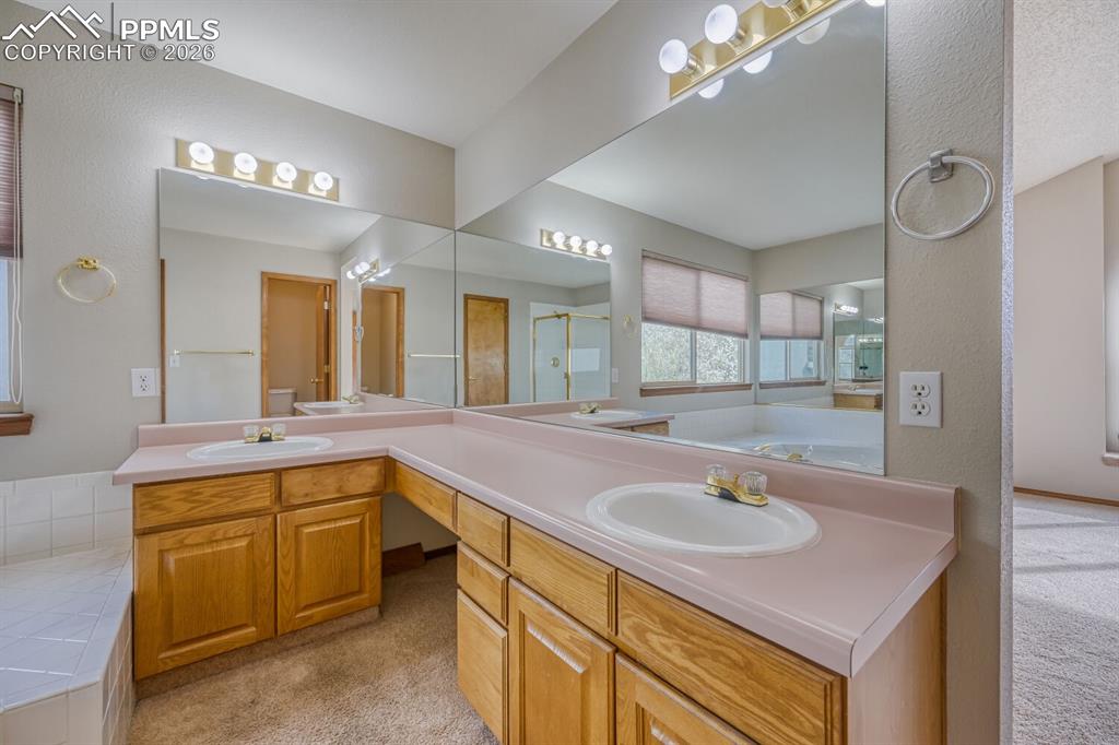 7215 Native Circle Colorado Springs, CO 80919 - Photo 18 of 30 a bathroom with a sink double vanity and a mirror