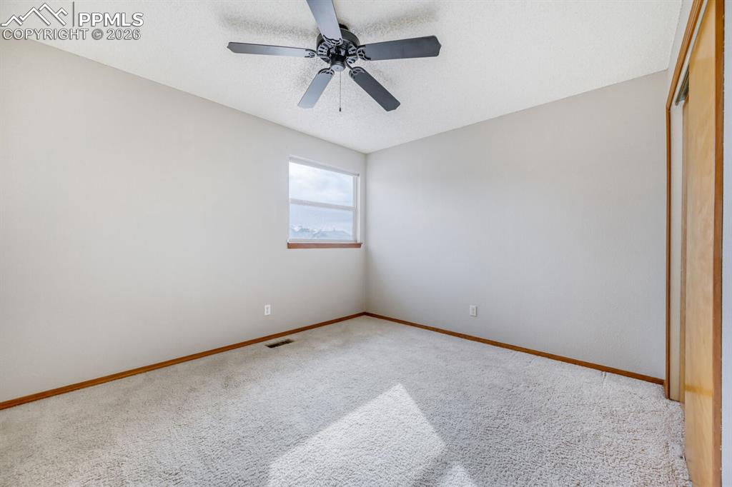7215 Native Circle Colorado Springs, CO 80919 - Photo 23 of 30 an empty room with a window and a fan