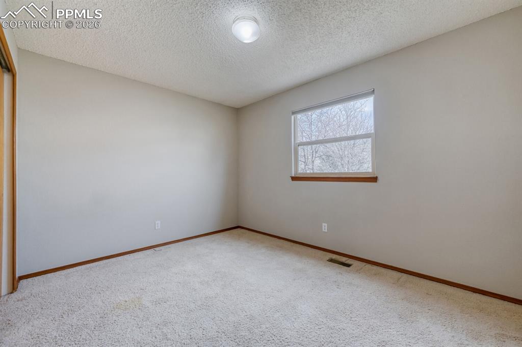 7215 Native Circle Colorado Springs, CO 80919 - Photo 24 of 30 a view of an empty room with a window