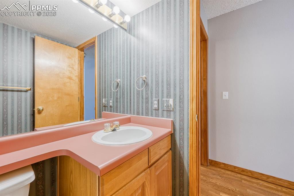 7215 Native Circle Colorado Springs, CO 80919 - Photo 28 of 30 a bathroom with a sink and a mirror