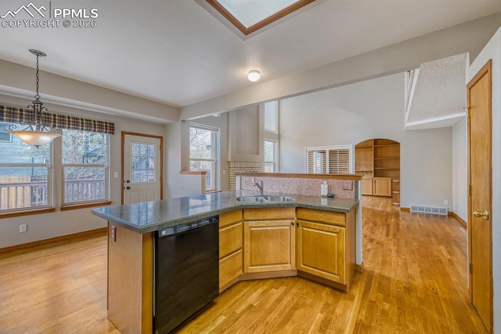 7215 Native Circle Colorado Springs, CO 80919 - Photo 6 of 30 a kitchen with sink cabinets and wooden floor