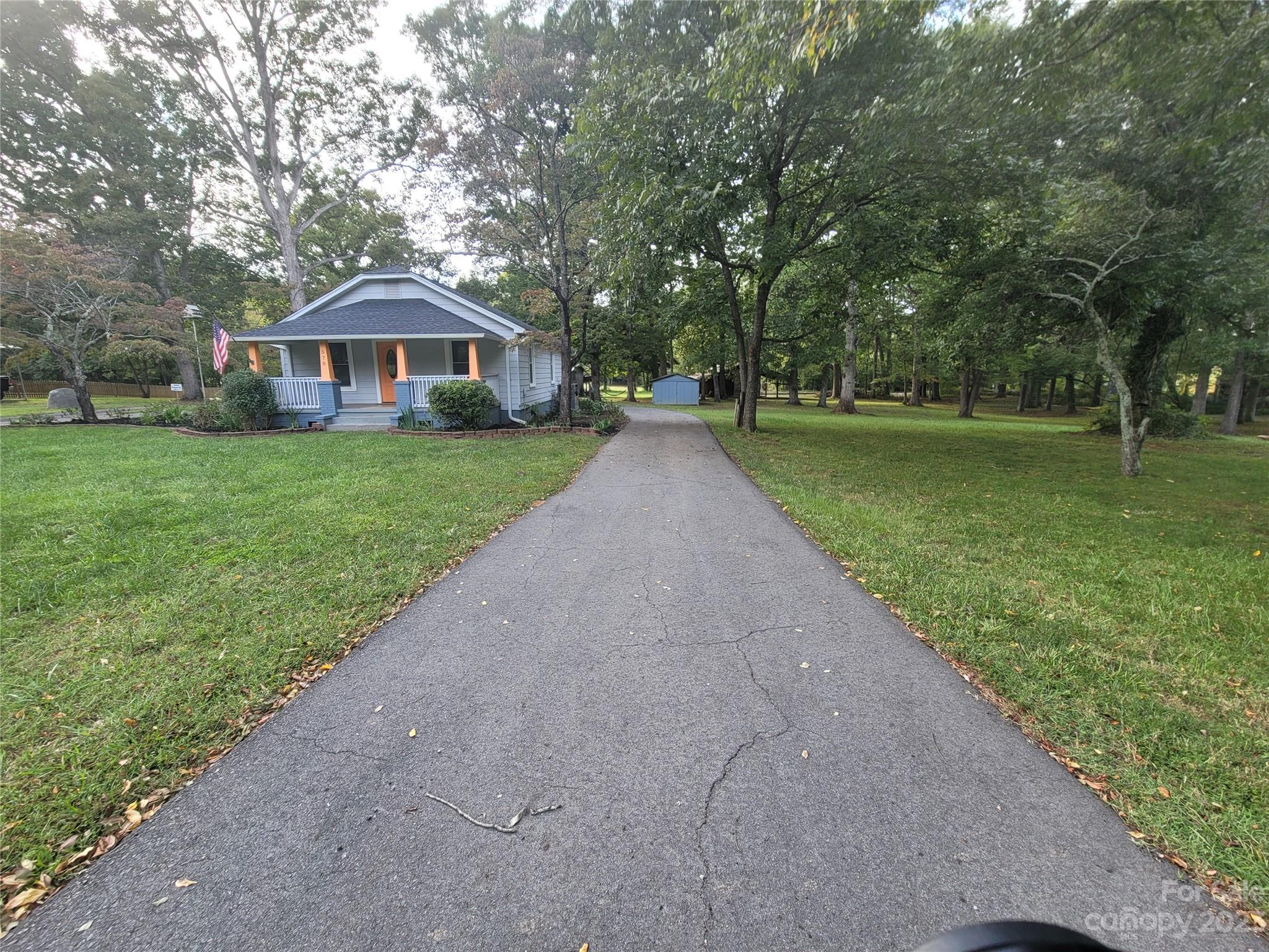 570 Crescent Road Rockwell, NC 28138 - Photo 1 of 28 a front view of a house with garden