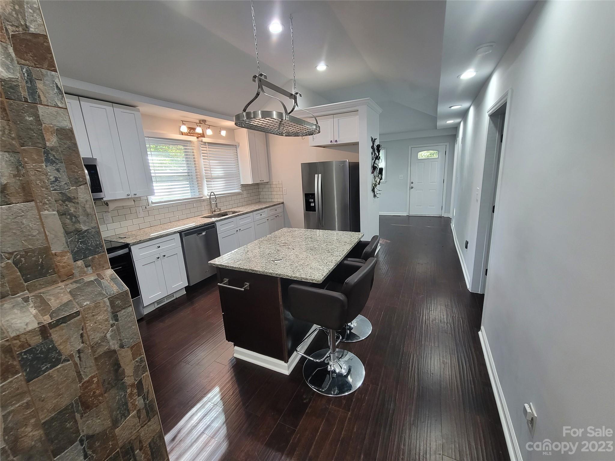 570 Crescent Road Rockwell, NC 28138 - Photo 11 of 28 a kitchen with granite countertop white cabinets a refrigerator and a stove