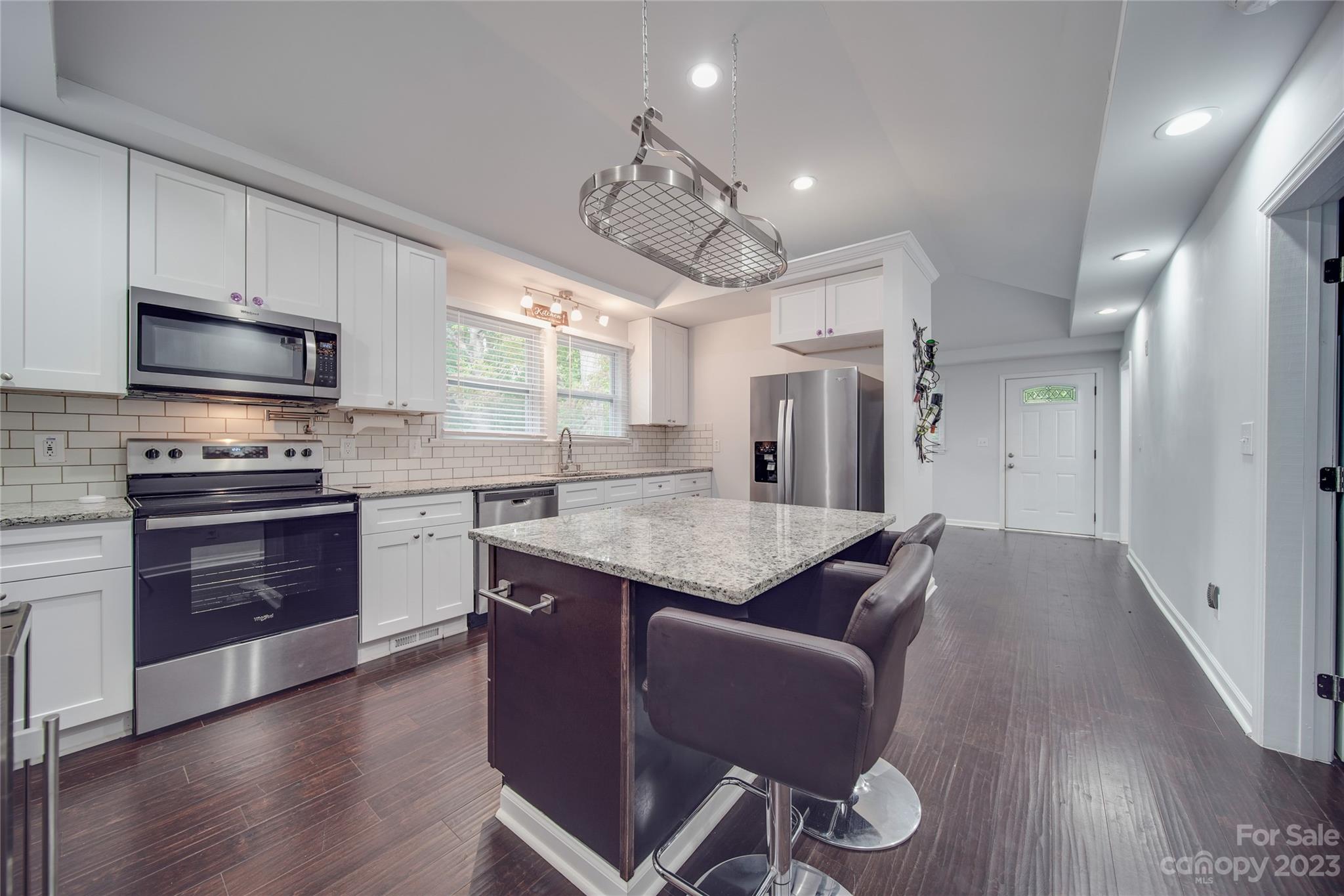 570 Crescent Road Rockwell, NC 28138 - Photo 12 of 28 a kitchen with granite countertop a sink cabinets and stainless steel appliances