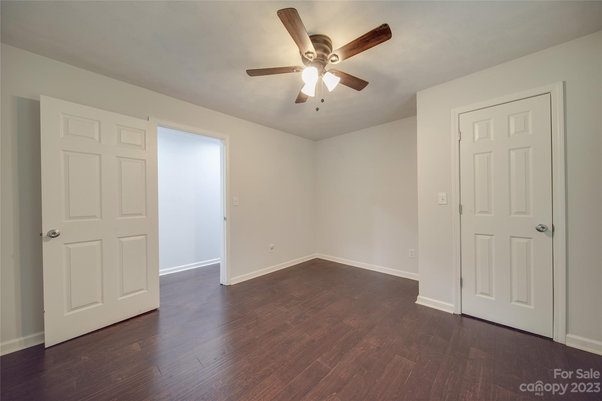 570 Crescent Road Rockwell, NC 28138 - Photo 14 of 28 an empty room with wooden floor and ceiling fan