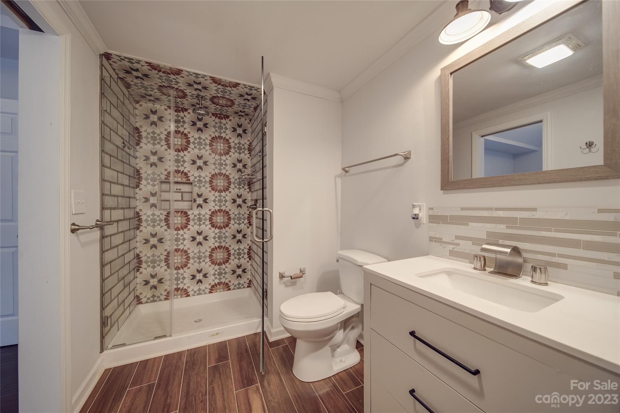 570 Crescent Road Rockwell, NC 28138 - Photo 17 of 28 a bathroom with a sink toilet a mirror and shower