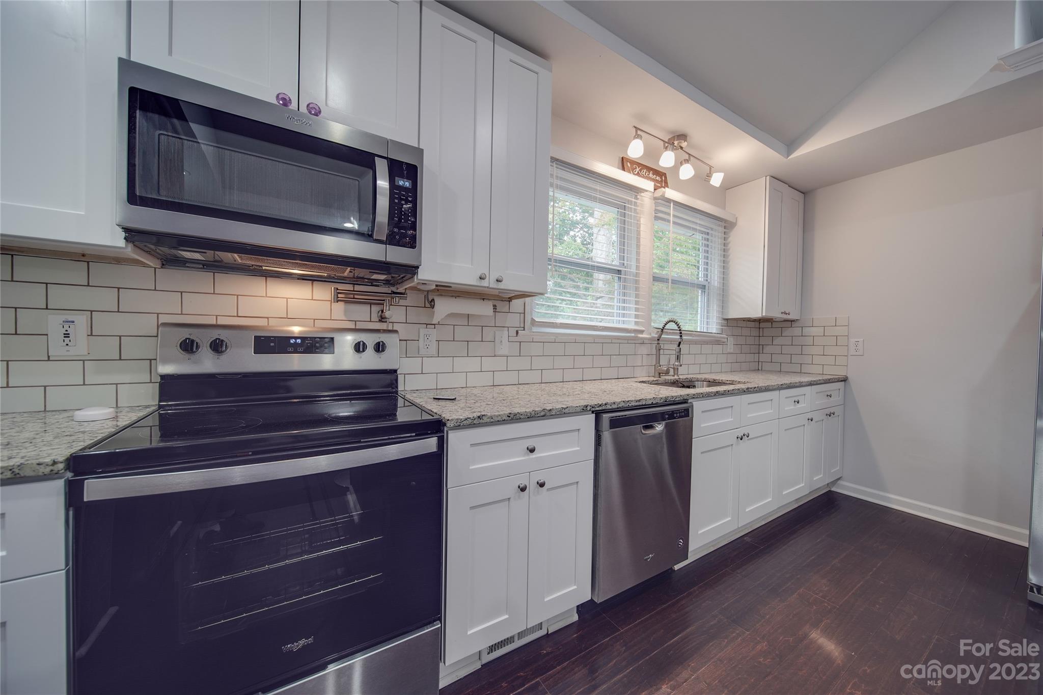 570 Crescent Road Rockwell, NC 28138 - Photo 21 of 28 a kitchen with sink a microwave a stove and cabinets