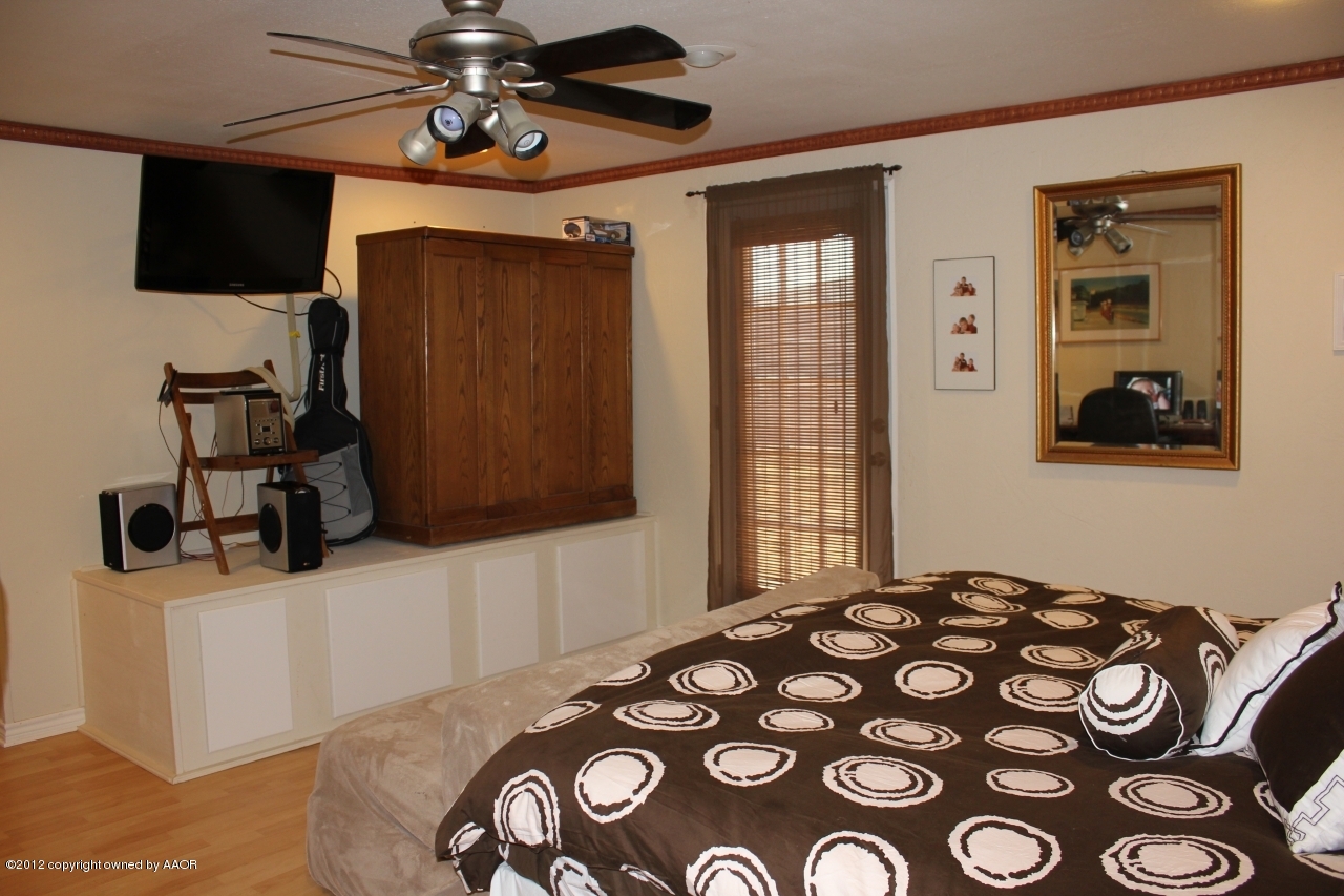 3609 Beacon Road Amarillo, TX 79118 - Photo 3 of 26 a bedroom with a bed and a flat screen tv