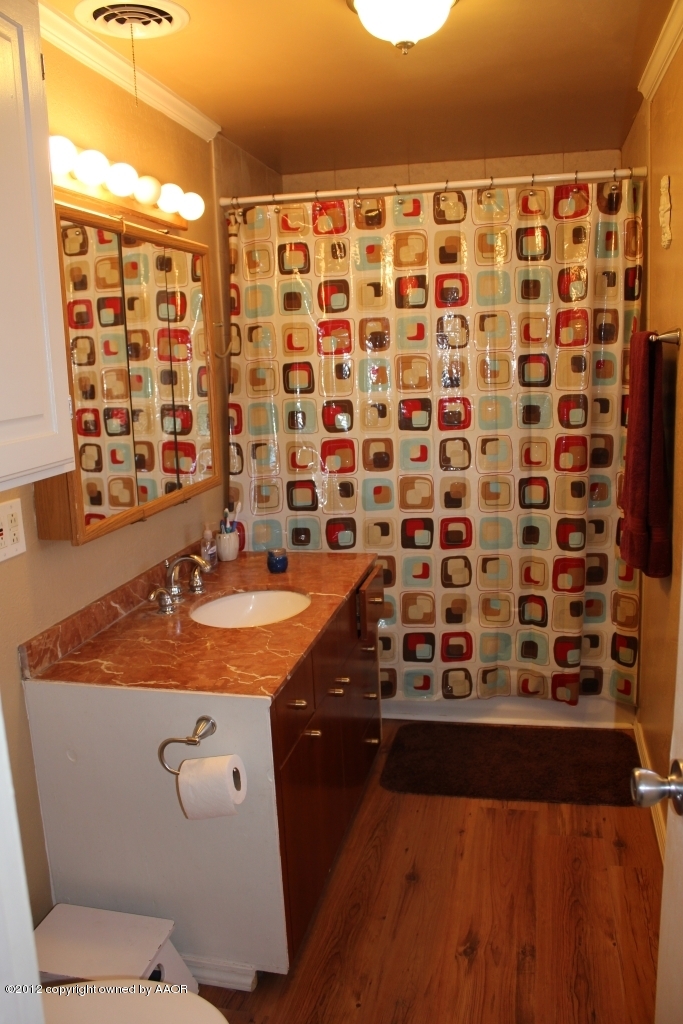3609 Beacon Road Amarillo, TX 79118 - Photo 5 of 26 a bathroom with a granite countertop sink a toilet and shower