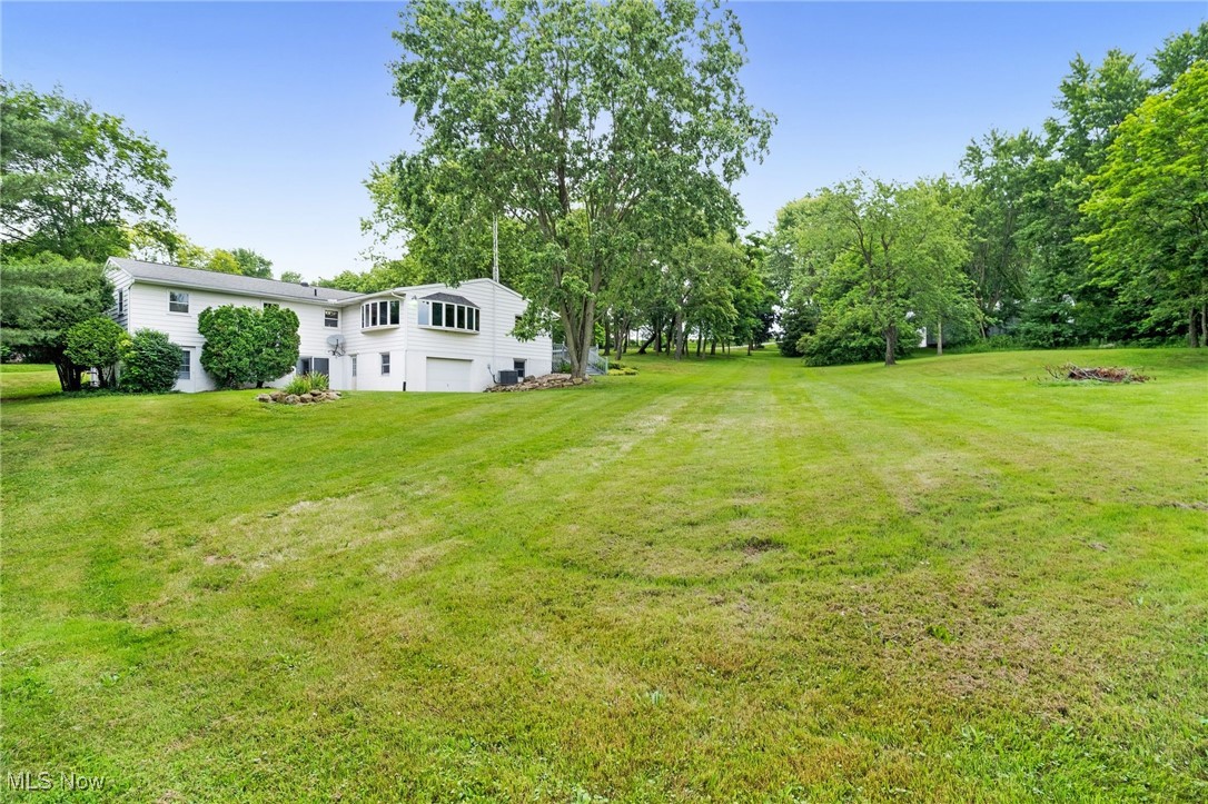 7923 Zigler Road Sterling, OH 44276 - Photo 25 of 31 View of green lawn with an attached garage