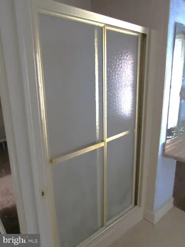 a bathroom with a glass shower door