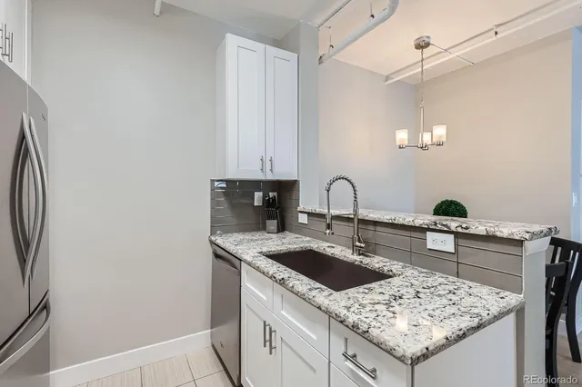 a kitchen with granite countertop cabinets and steel stainless steel appliances