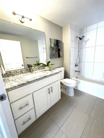 a living room with furniture and a lamp