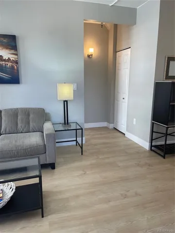 a view of a room with wooden floor and tub