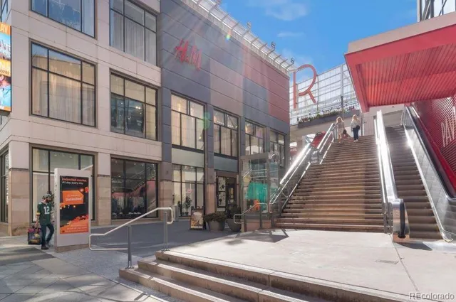 a view of a patio with a table and chairs under an umbrella