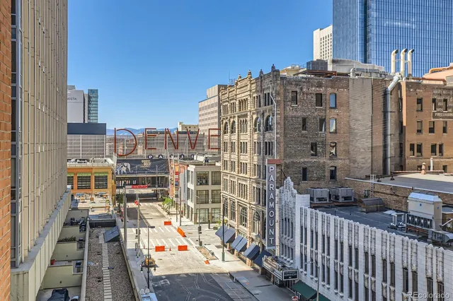 a kitchen with granite countertop a dining table chairs and stainless steel appliances