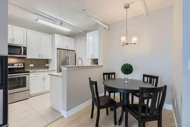 a kitchen with granite countertop cabinets and steel stainless steel appliances