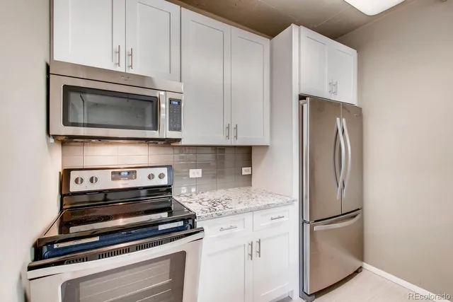 a kitchen with a sink and a refrigerator
