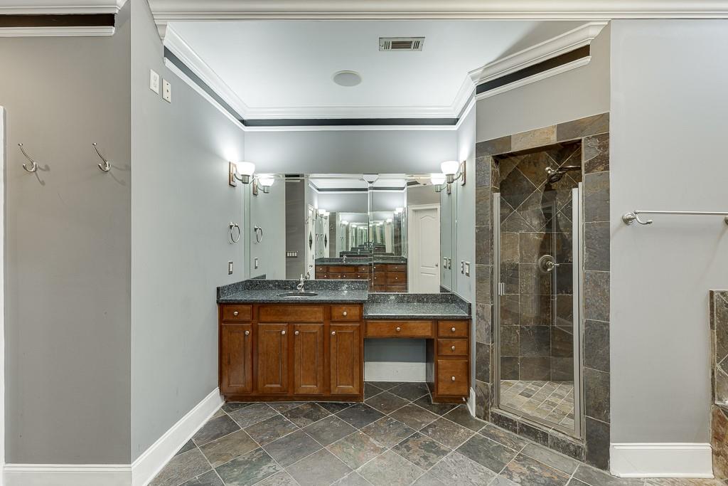 940 Chateau Forest Road Hoschton, GA 30548 - Photo 38 of 87 a bathroom with a granite countertop sink mirror and shower