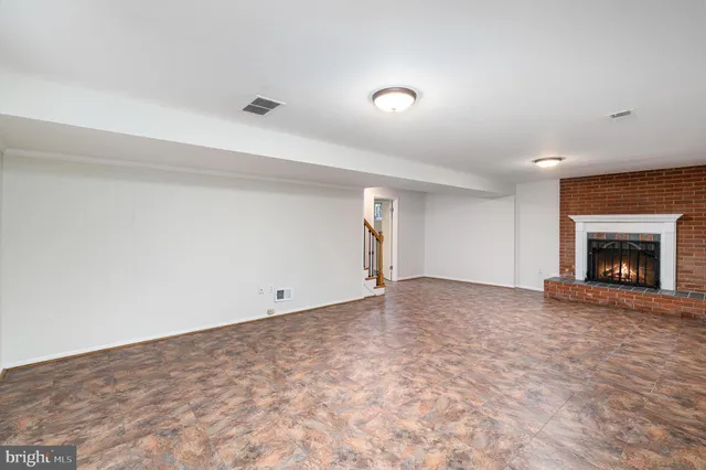 a view of empty room with window and fireplace