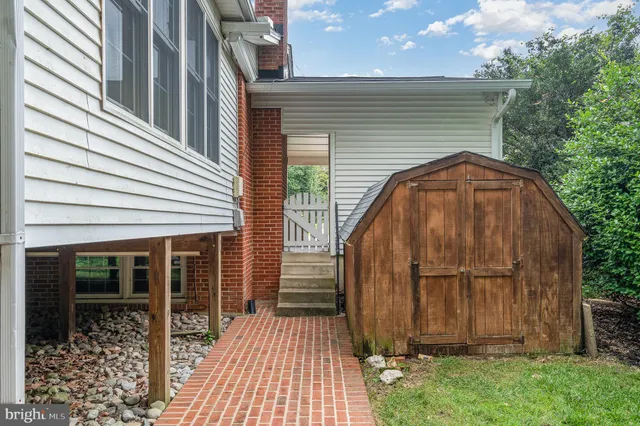 a view of backyard with cabin and wooden fence