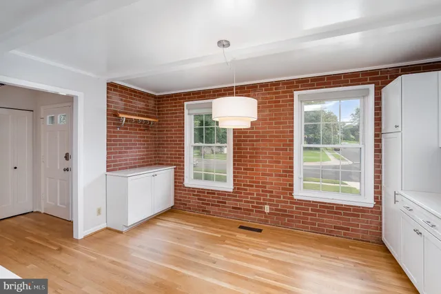 a view of a room with wooden floor and windows