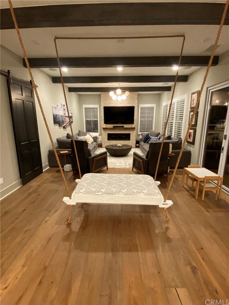 114 Joshua Tree Irvine, CA 92620 - Photo 12 of 73 a living room with stainless steel appliances furniture a fireplace and a flat screen tv