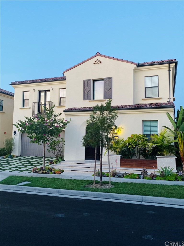 114 Joshua Tree Irvine, CA 92620 - Photo 3 of 73 a front view of a house with a garden and plants