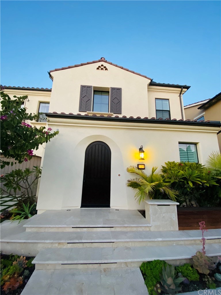 114 Joshua Tree Irvine, CA 92620 - Photo 4 of 73 a front view of a house with yellow lighting