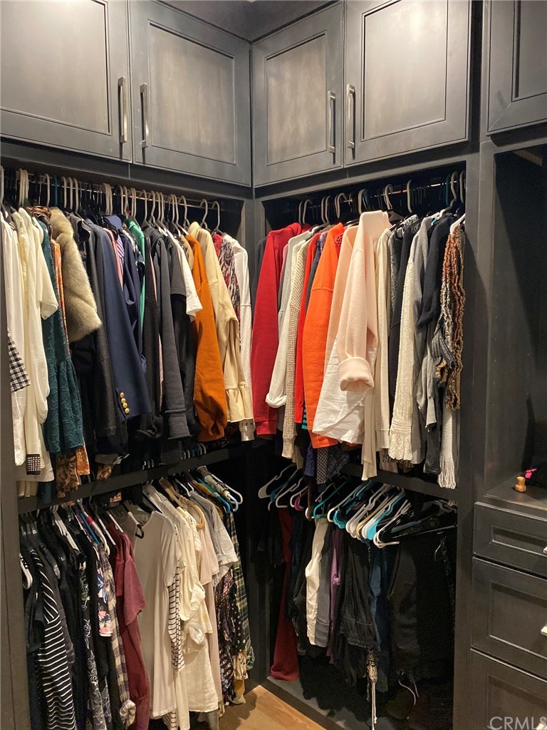 114 Joshua Tree Irvine, CA 92620 - Photo 49 of 73 a view of walk in closet with clothes and shoes