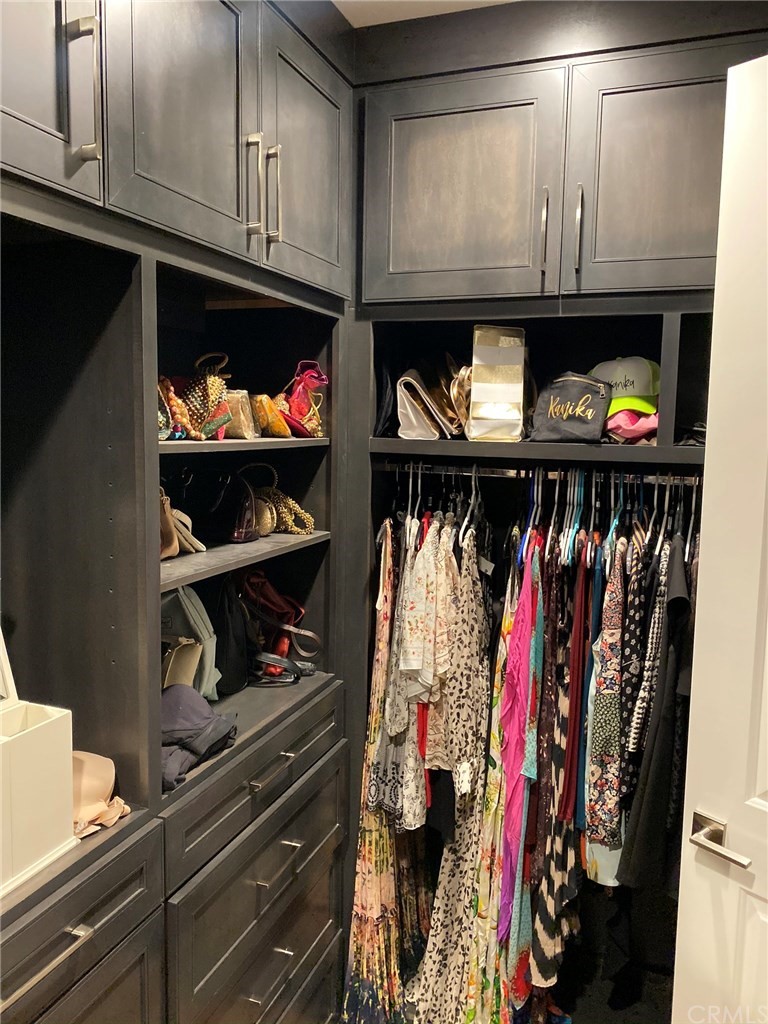 114 Joshua Tree Irvine, CA 92620 - Photo 50 of 73 a view of walk in closet with clothes and shoes