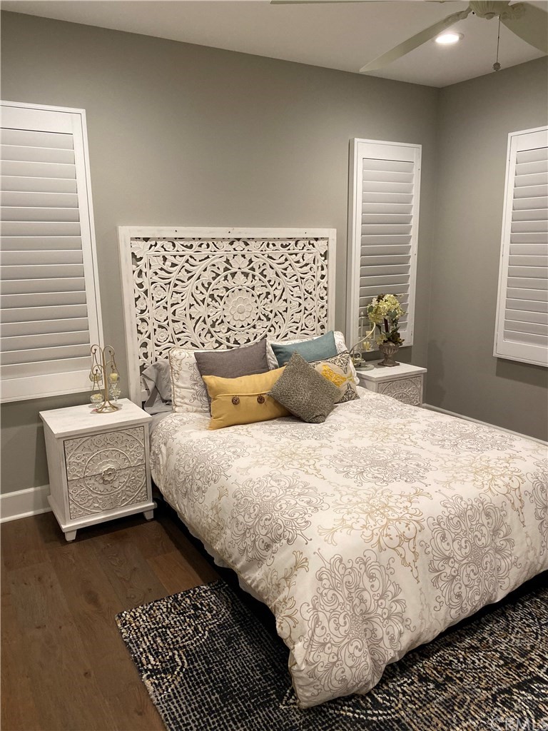 114 Joshua Tree Irvine, CA 92620 - Photo 58 of 73 a bedroom with a bed and wooden floor