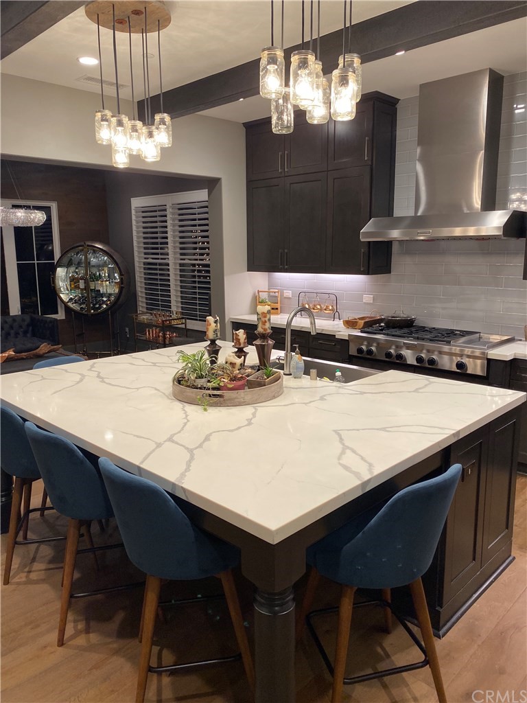114 Joshua Tree Irvine, CA 92620 - Photo 64 of 73 a kitchen with a table chairs and a chandelier
