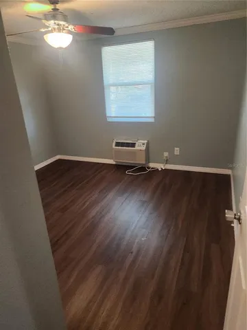 a view of room with hardwood floor and window