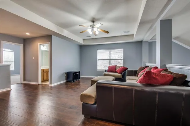 a living room with furniture a wooden floor and chandelier