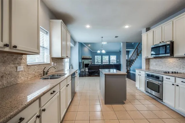 a bathroom with a bath tub sink mirror vanity and toilet