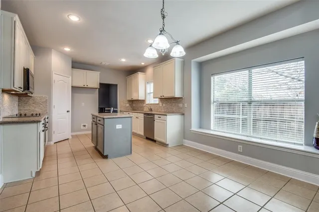 a kitchen with a sink cabinets and stainless steel appliances
