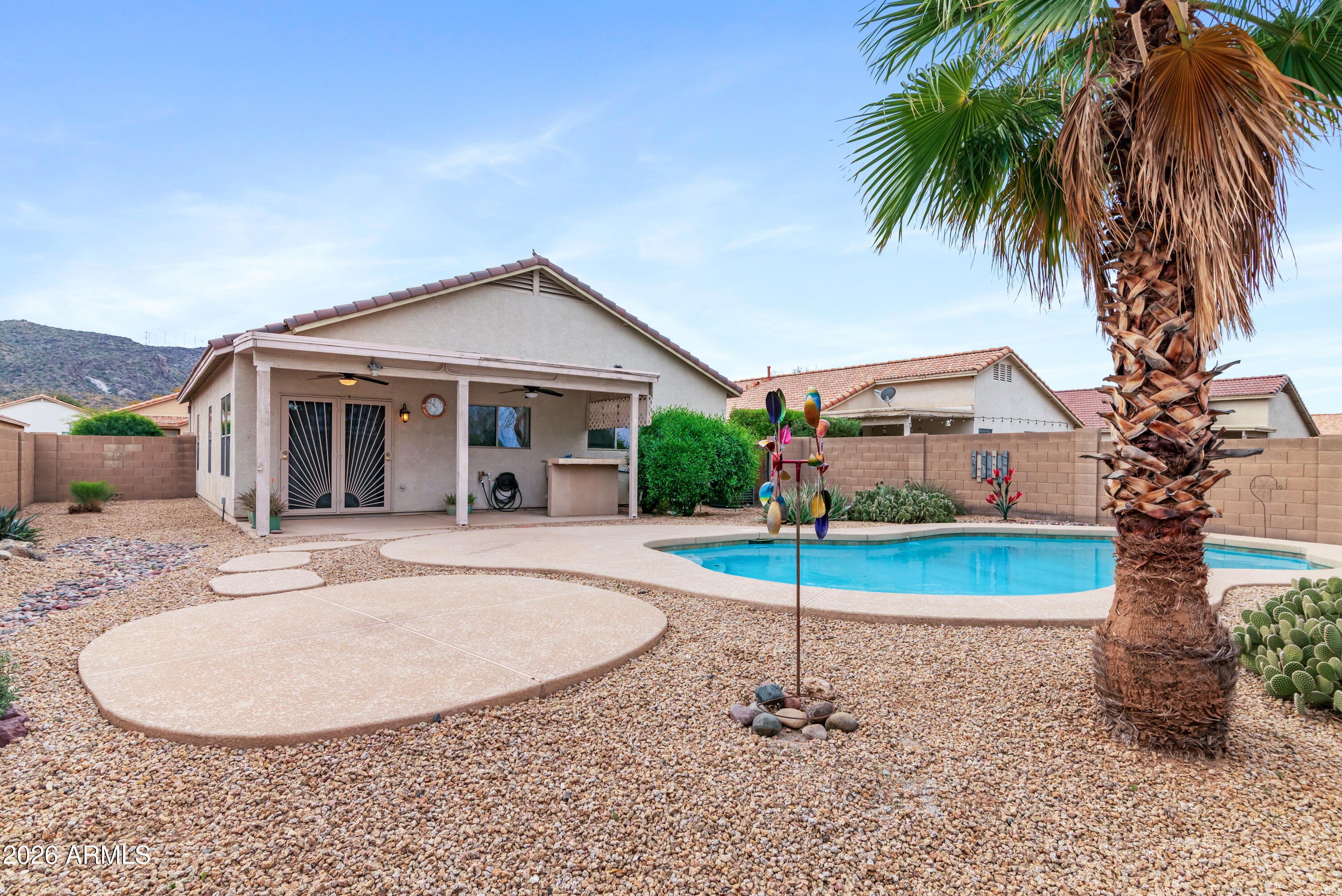 a view of a house with a swimming pool and a yard