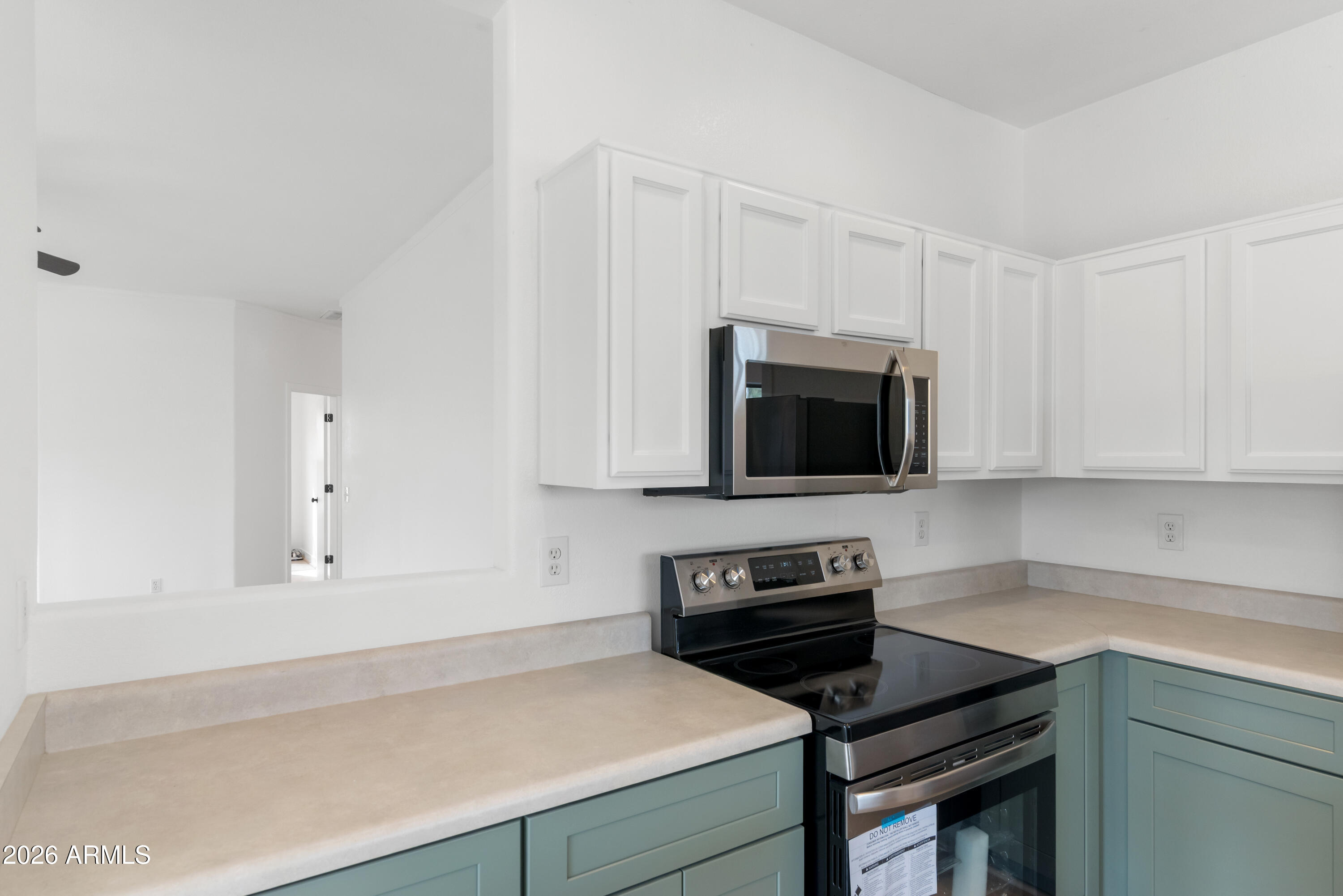 930 East Pedro Road Phoenix, AZ 85042 - Photo 11 of 34 a kitchen with a sink and a stove top oven with white kitchen