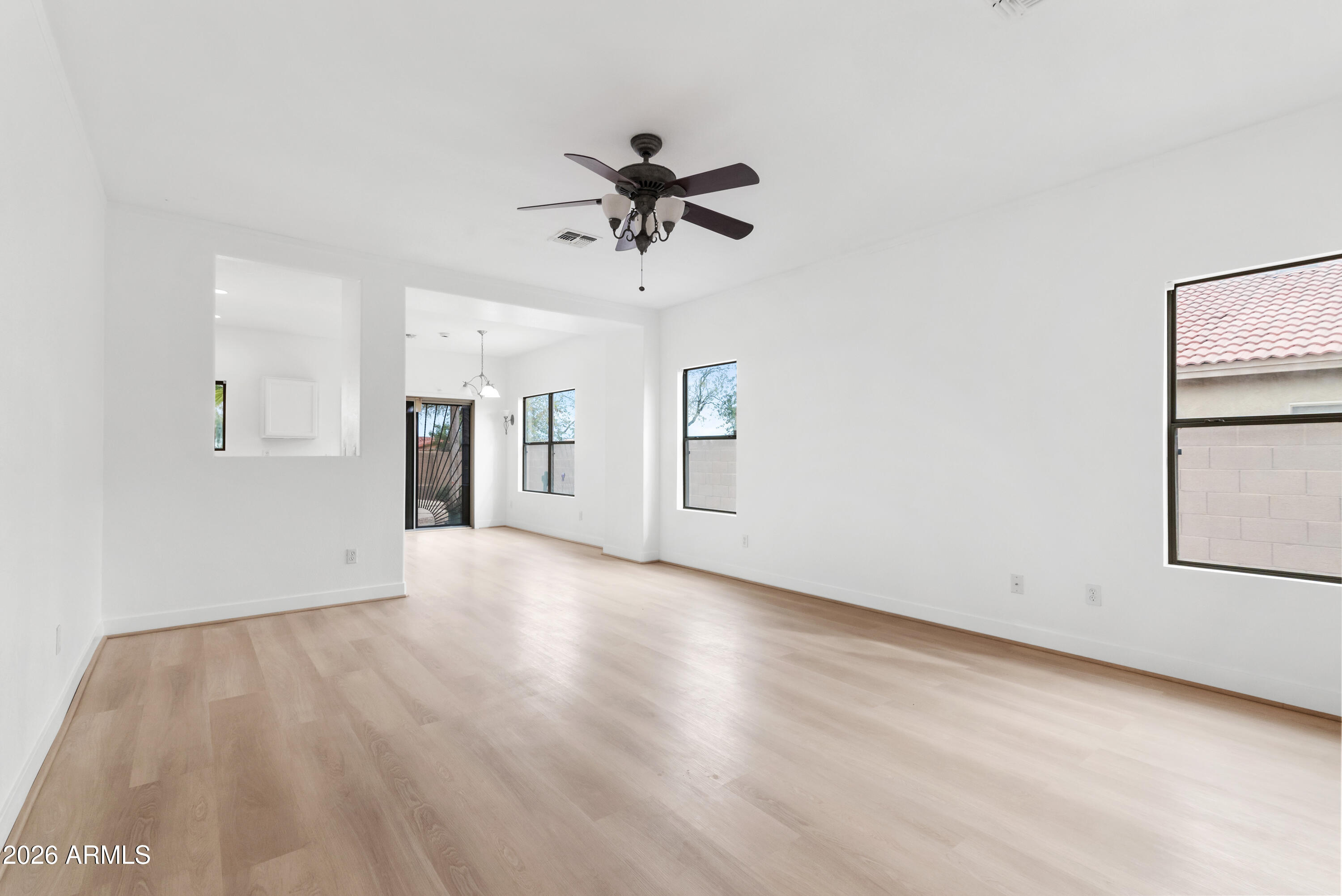 930 East Pedro Road Phoenix, AZ 85042 - Photo 14 of 34 wooden floor in an empty room with a window
