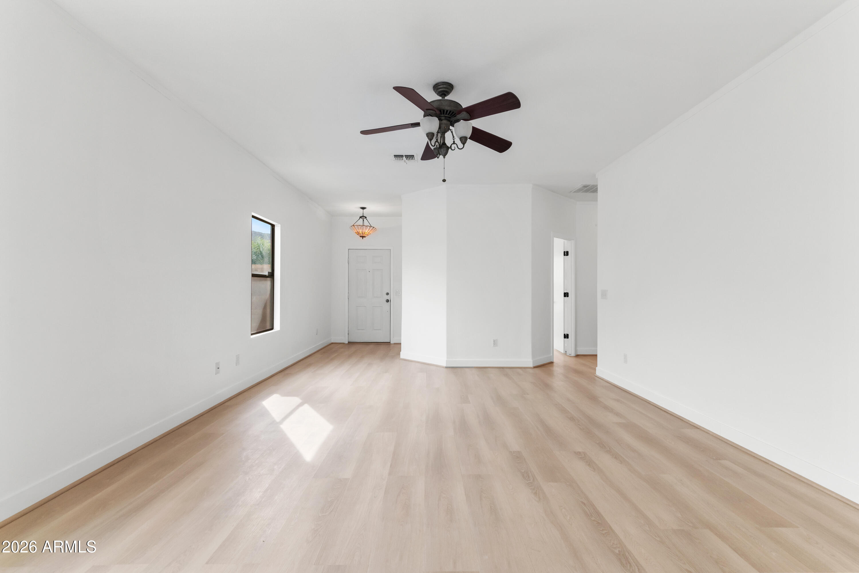 930 East Pedro Road Phoenix, AZ 85042 - Photo 15 of 34 a view of a livingroom with a hardwood floor and a ceiling fan
