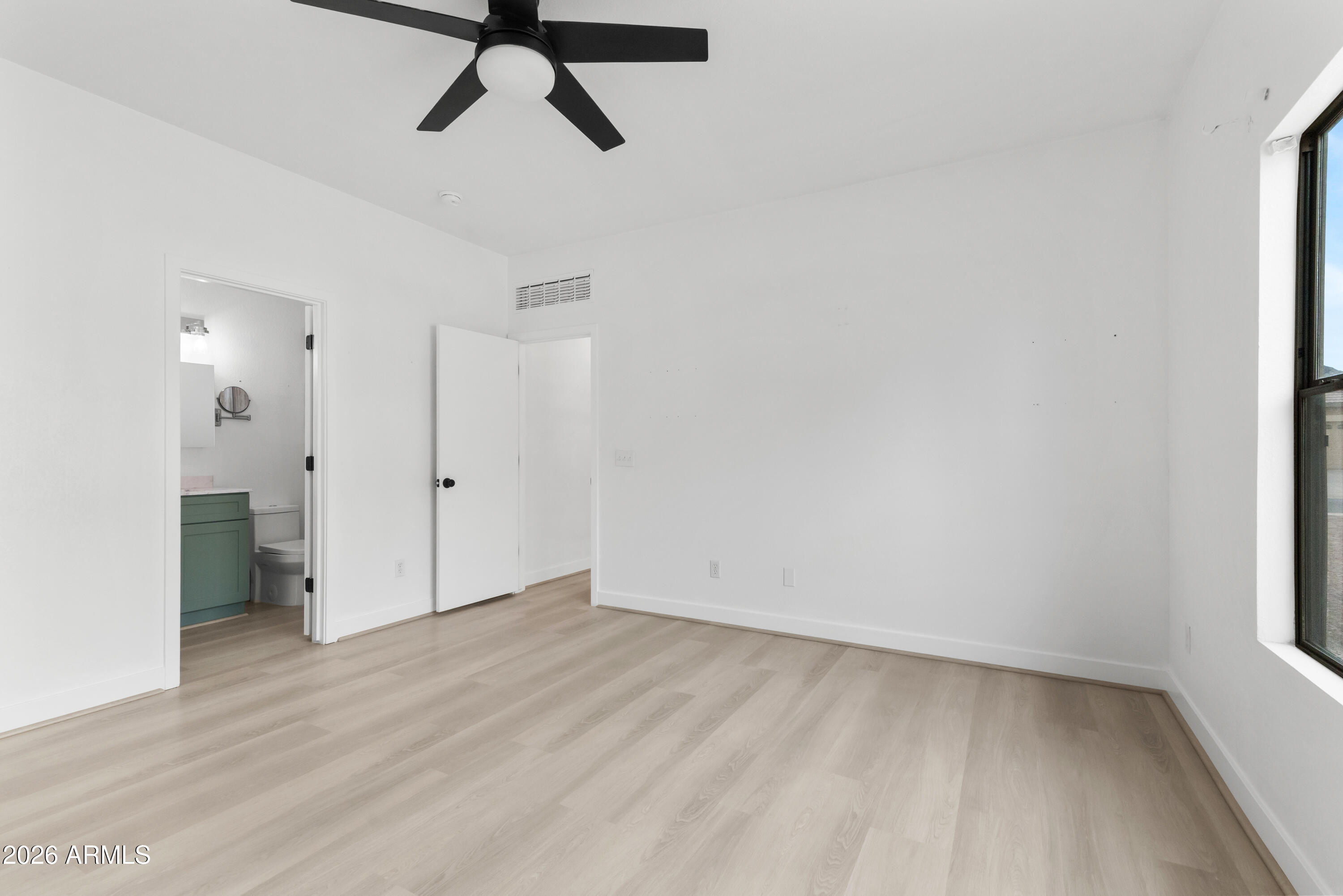 930 East Pedro Road Phoenix, AZ 85042 - Photo 17 of 34 a view of a room with wooden floor and natural light